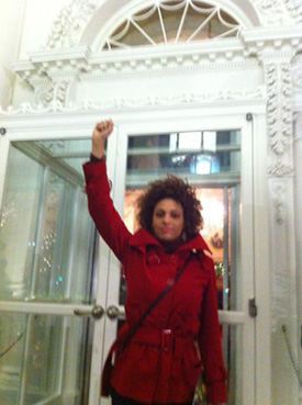 Lori raising the black power fist at the main door of the White House
