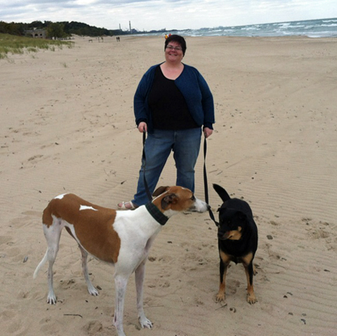 Melissa on the beach with her two dogs