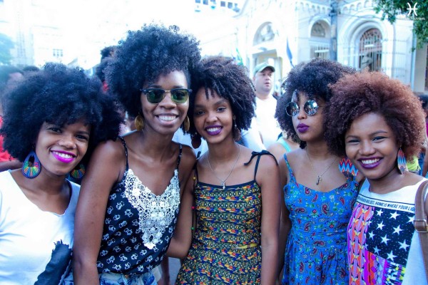 Young Black women with natural hair pose for a picture.