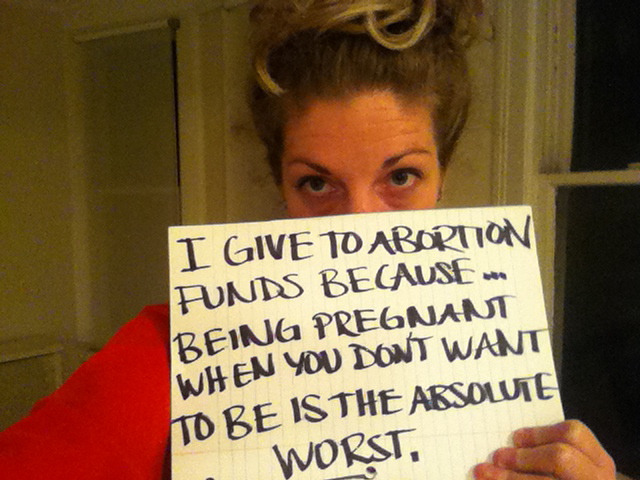 sign that says "i give to abortion funds because being pregnant when you don't want to be is the absolute worst."