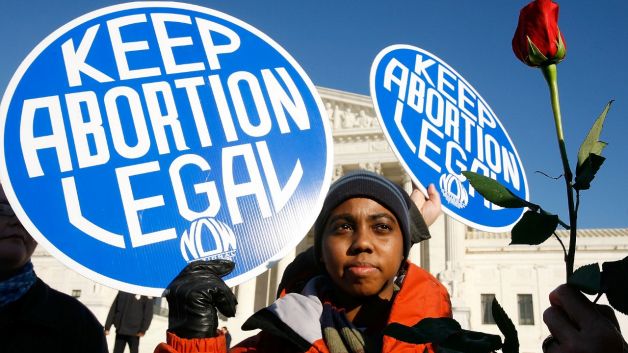 black woman protestor with "keep abortion legal" sign
