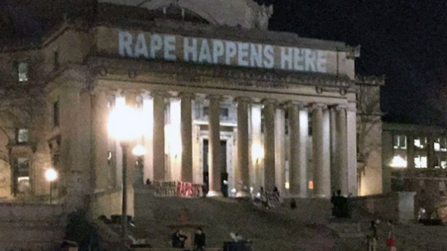 "rape happens here" on the library facade