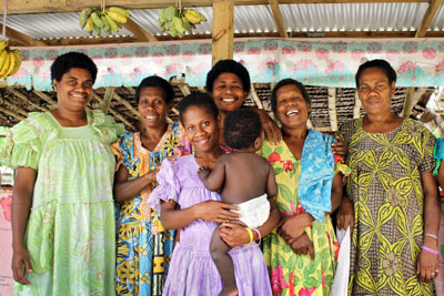 Market vendors pose for a photograph under the shade of the recently-built Epau road market on Efate Island in Vanuatu in 2014. Photo: UN Women/Olivia Owen