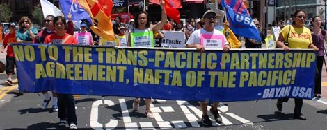 Protestors hold a sign saying "No to the Trans-Pacific Parternship, NAFTA of the Pacific."