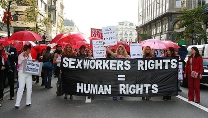 protest sign saying "sex workers rights = human rights"