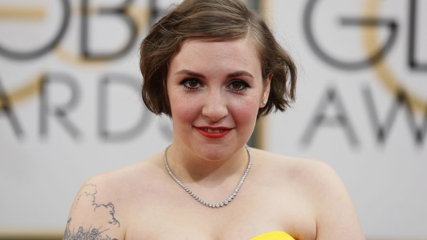 lena dunham (a white lady with chin length brown hair, wearing a strapless yellow thing and pearls)