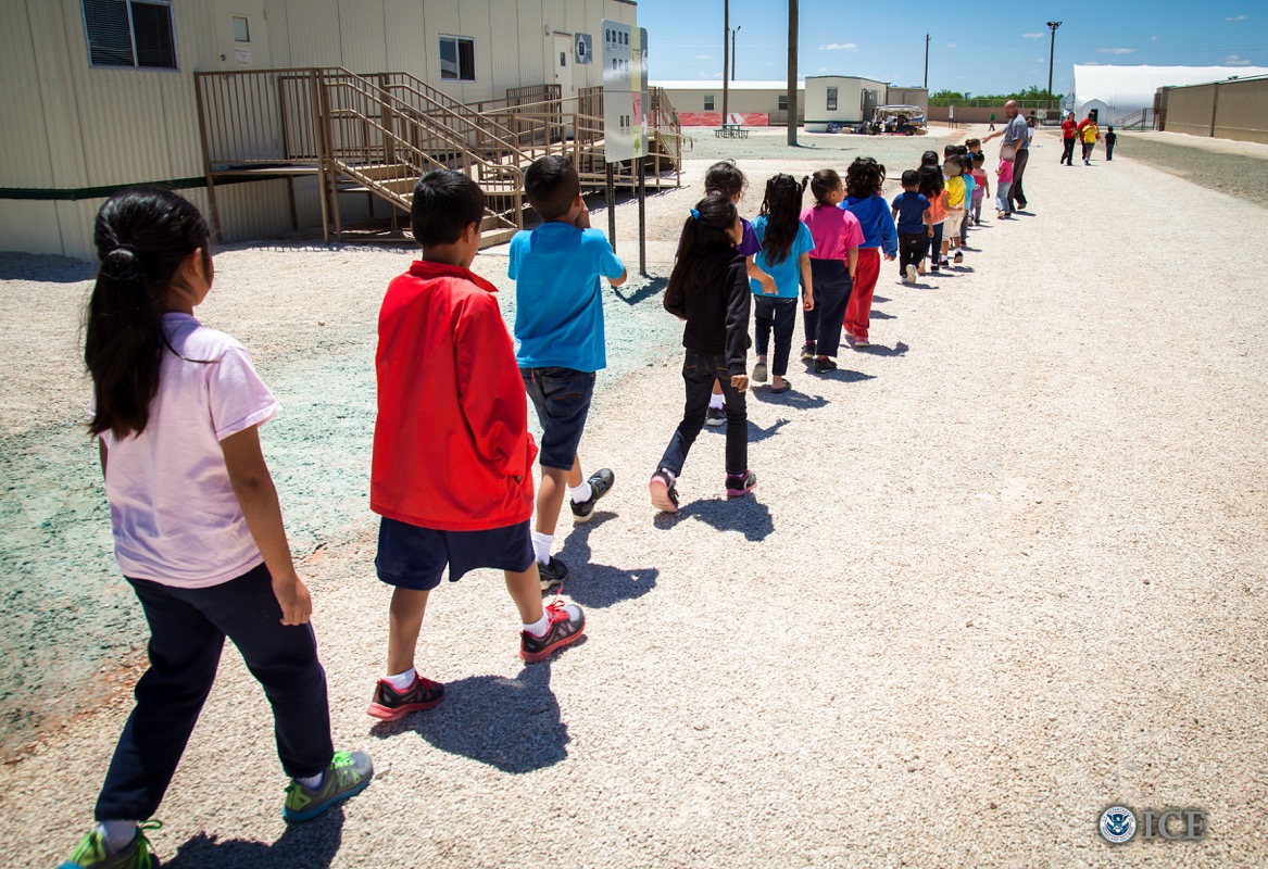Children walk to classrooms at the Dilley detention center.
