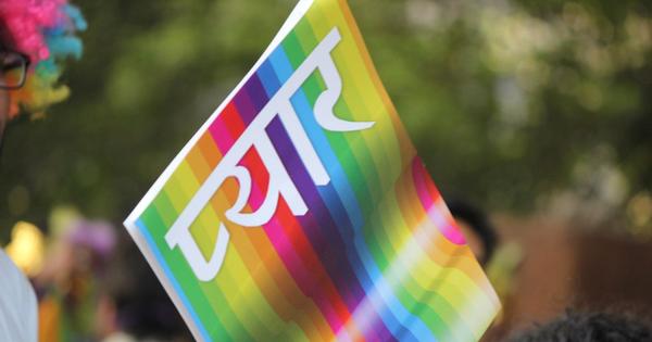 rainbow flag that says "love" in Hindi