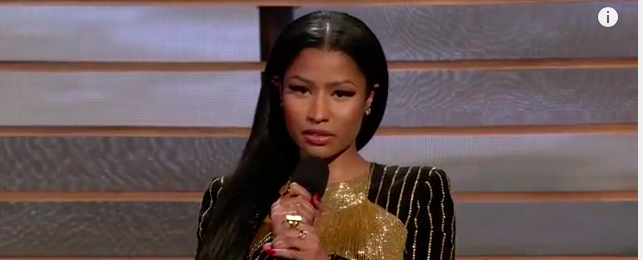 Nicki Minaj, reading poem text into a microphone.