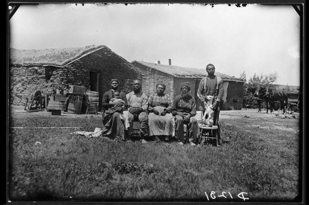 The Shores family pose for a portrait near Westerville, Custer County, Neb., in 1887. Jerry Shores was one of a number of former slaves to settle in Custer County. He took a claim adjacent to that of his brothers, Moses Speese and Henry Webb. Each had taken the name of his former owner. They are among the thousands of homesteaders who moved west in the late 1800's and set up housekeeping with the only natural resource the Great Plains had in abundance: sod.  (AP Photo)