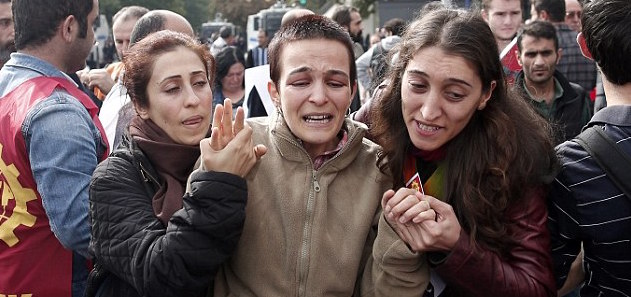 Three women comfort each other in the wake of a car bombing in Ankara, Turkey.