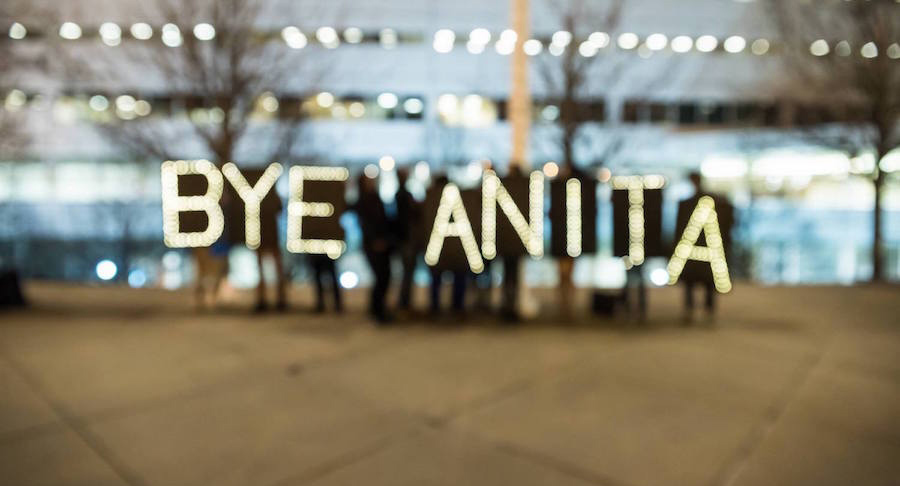 Protesters hold up lighted letters that read BYE ANITA