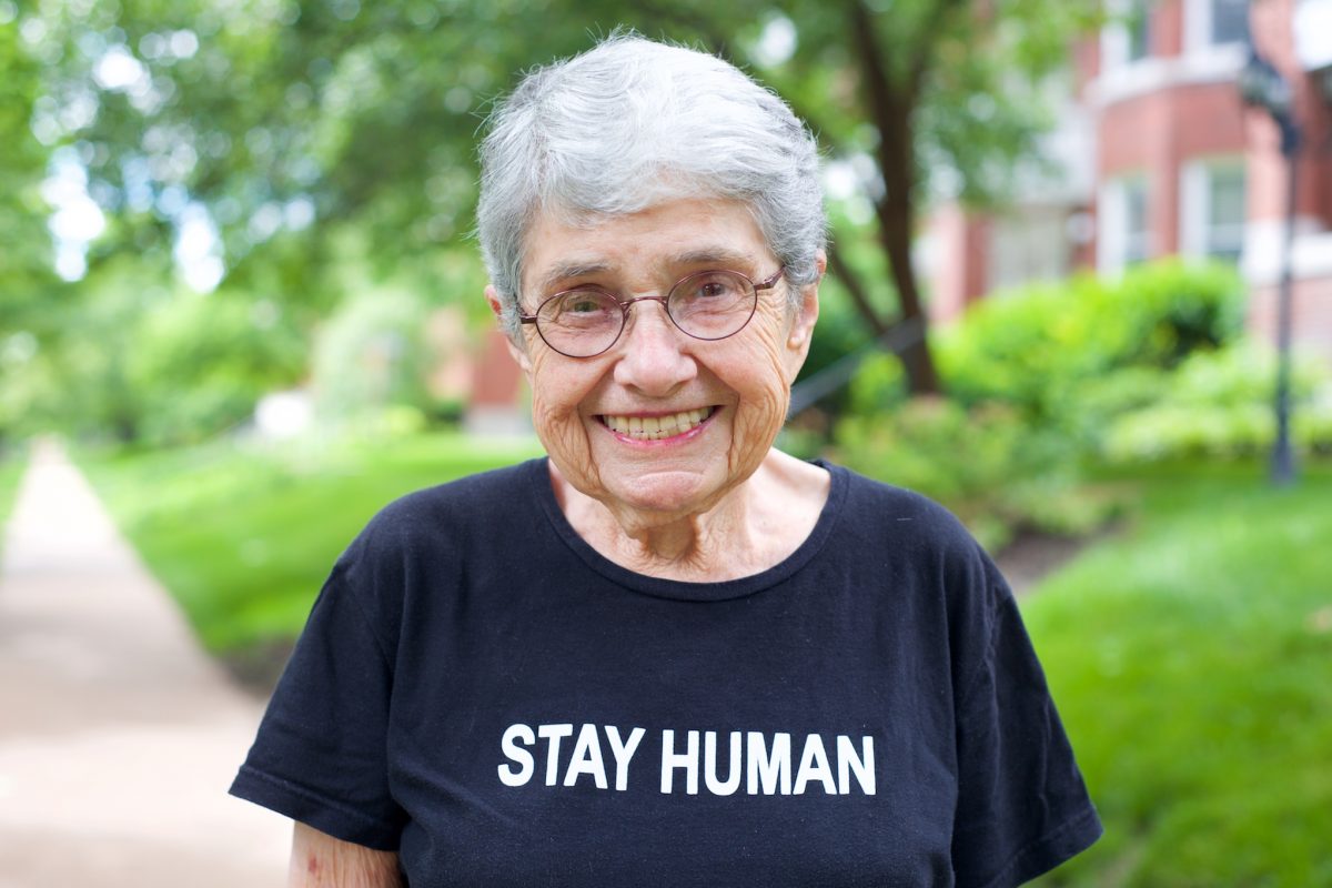 Hedy Epstein smiling and wearing a shirt that says "Stay Human"