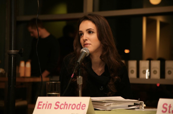 Erin Schrode sits at a desk speaking