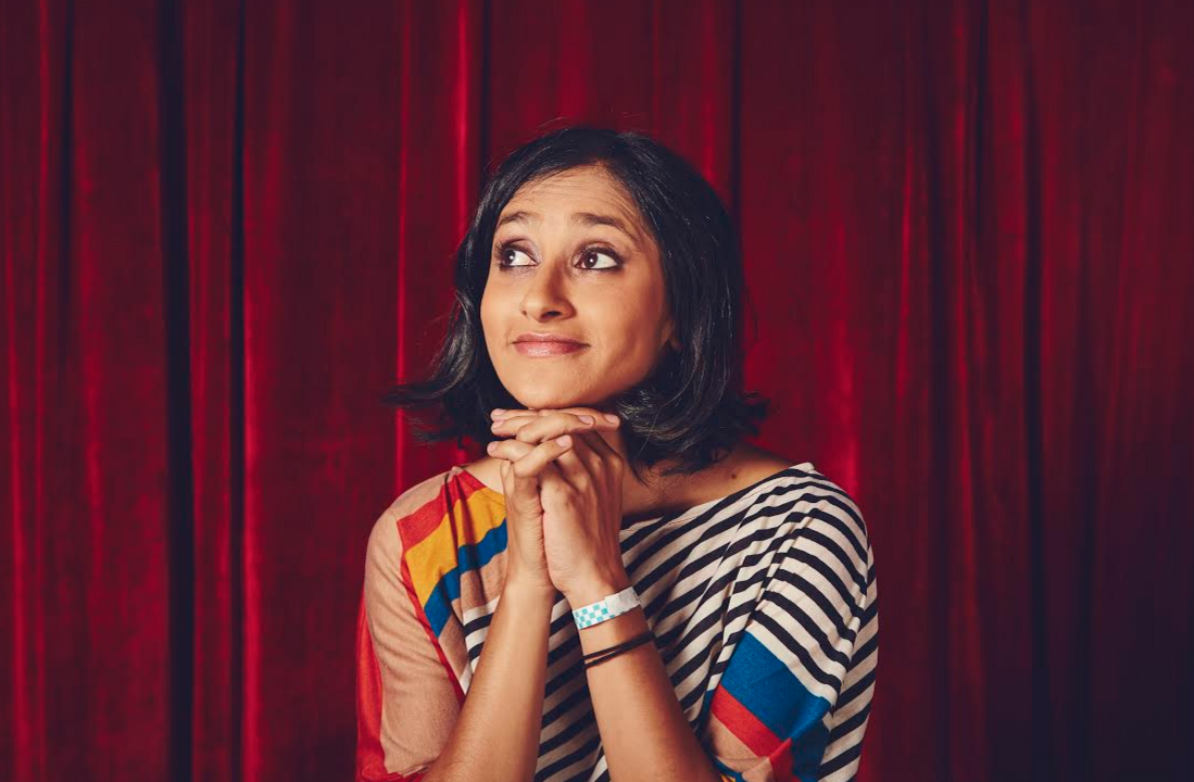 aparna nancherla with a red curtain background