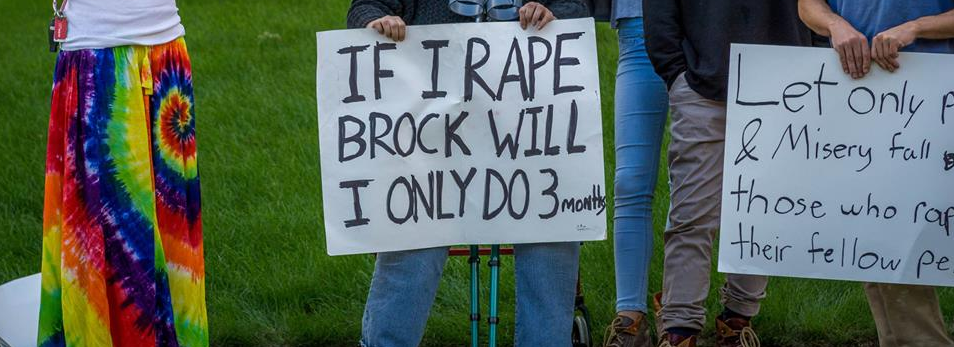 Protestor outside Brock Turner's house holds up a sign declaring, "If I Rape Brock Will I Only Do 3 Months"