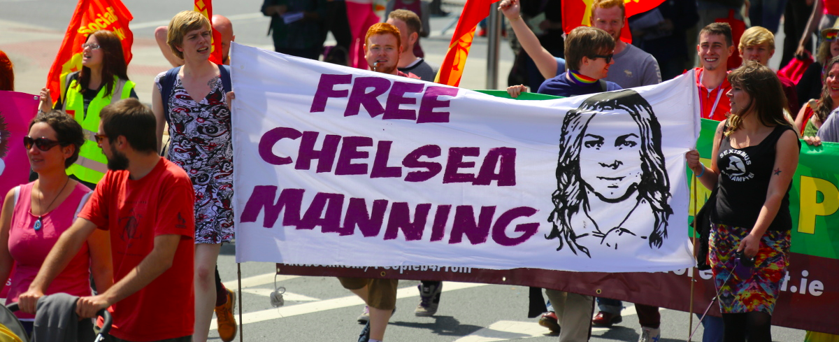 people holding up a free chelsea manning poster