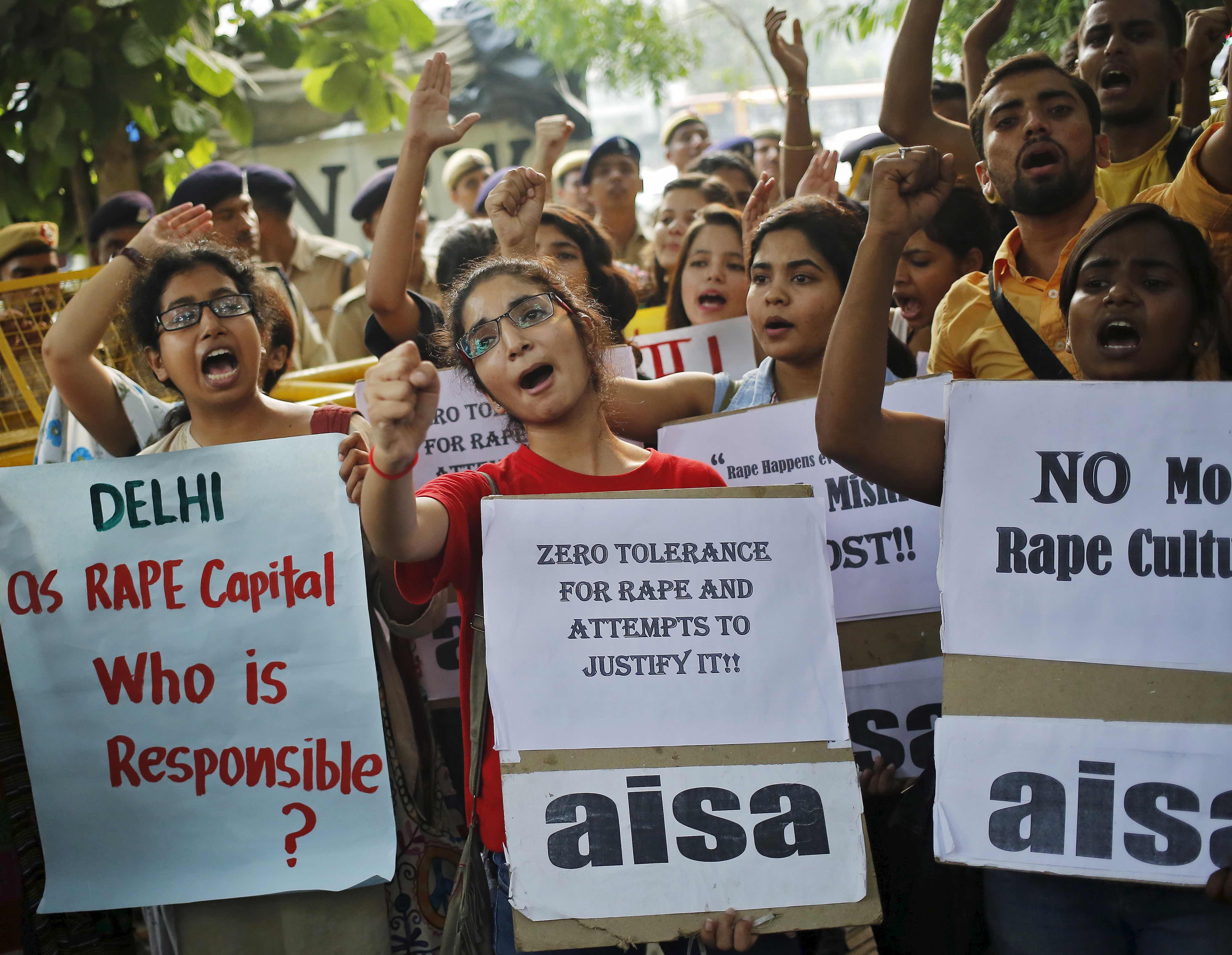 Members of All India Students Association (AISA) shout slogans as they hold placards during a protest outside police headquarters in New Delhi, India, October 18, 2015. Dozens of AISA members on Sunday held a protest against the recent rapes in the capital, the demonstrators said. REUTERS/Anindito Mukherjee - RTS4YAL
