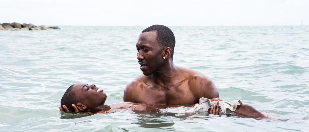 This image released by A24 Films shows Alex Hibbert, left, and Mahershala Ali in a scene from the film, "Moonlight."  The film is  a poetic coming-of-age tale told across three chapters about a young gay black kid growing up in a poor, drug-ridden neighborhood of Miami. (David Bornfriend/A24 via AP)