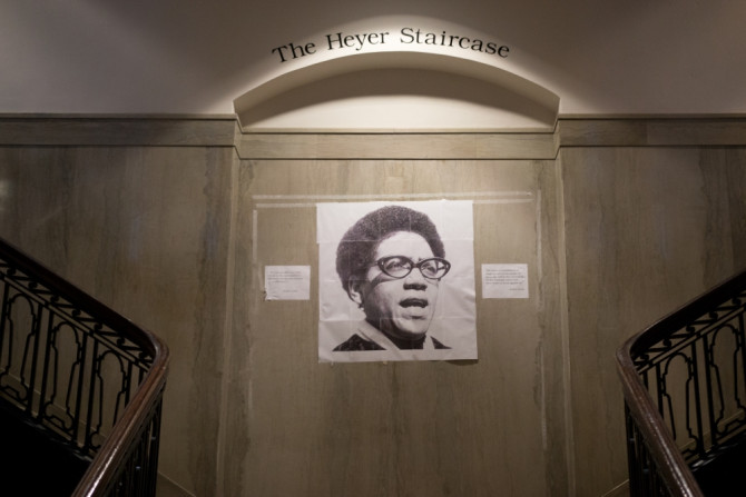 a photo of Audre Lorde is taped over that of William Shakespear on a wall at UPenn