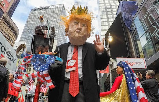 NEW YORK, NY - FEBRUARY 19: A man disguised as President Trump takes part in a rally called 'I Am A Muslim Too' in a show of solidarity with American Muslims at Times Square on February 19, 2017 in New York City.  A new version of a Trump administration travel ban will not stop green card holders or travelers already on planes from entering the United States, U.S. Secretary of Homeland Security John Kelly said. (Photo by Eduardo Munoz Alvarez/Getty Images)