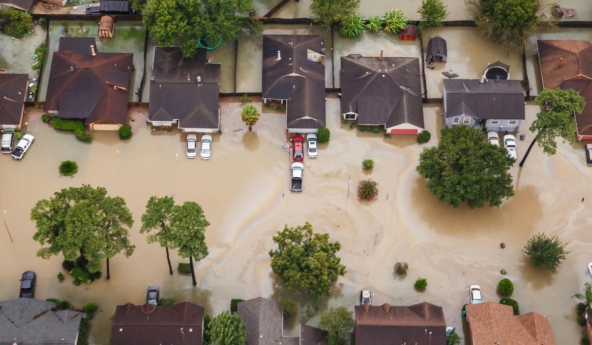 An aerial view of a street with homes hit by Hurricane Harvey
