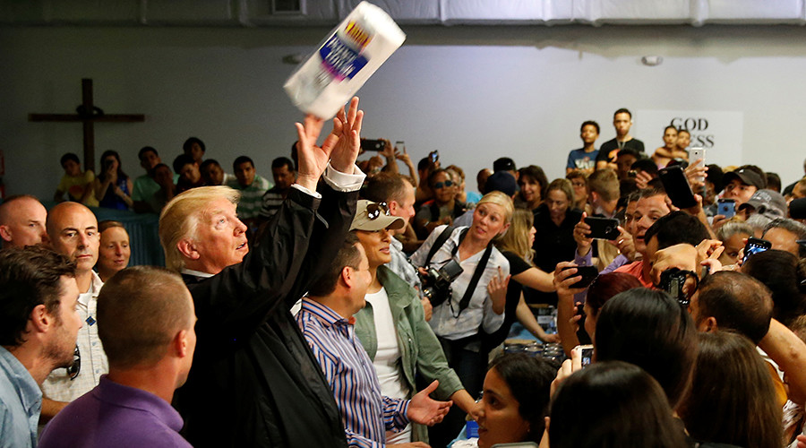 Trump throws paper towels into a crowd