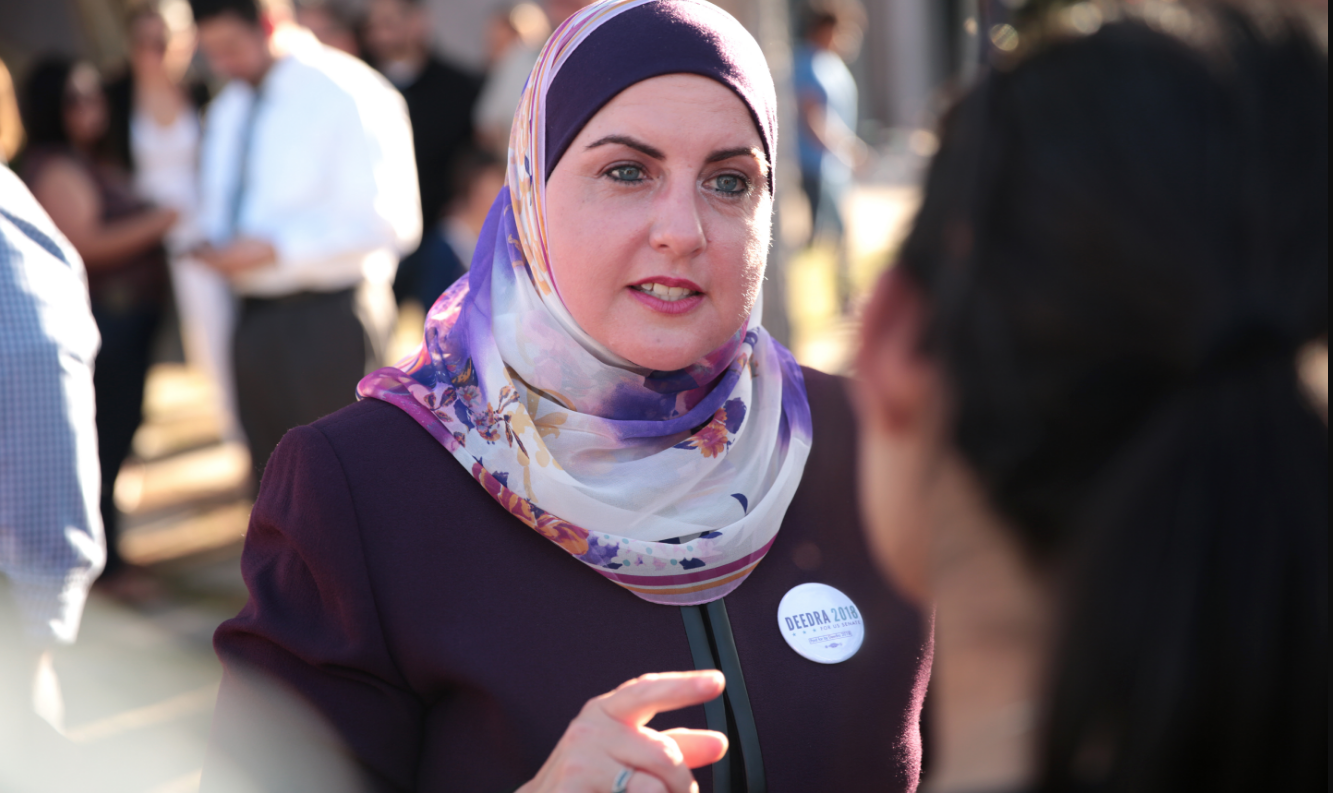 A woman with a headscarf, Deedra Abboud, speaks to constiuents.